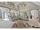 Open concept living space featuring elegant columns, a vaulted ceiling and neutral colors at 160 Isleworth Way, Fayetteville, GA 30215