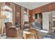 Cozy living room with dark wood paneling, traditional furnishings, and large windows with natural light at 160 Isleworth Way, Fayetteville, GA 30215
