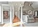 Bright, open-concept living room featuring elegant columns, hardwood floors, and neutral tones at 160 Isleworth Way, Fayetteville, GA 30215