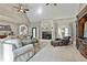 Comfortable living room with a cozy fireplace, plush seating, and lots of natural light at 160 Isleworth Way, Fayetteville, GA 30215