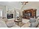 Living room showcasing a fireplace, vaulted ceiling, entertainment center, and comfortable seating at 160 Isleworth Way, Fayetteville, GA 30215