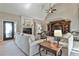 Comfortable living room area with a fireplace, dark wood entertainment center, and neutral colors at 160 Isleworth Way, Fayetteville, GA 30215