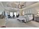 Spacious main bedroom featuring tray ceilings, neutral color palette, seating area and plush carpeting at 160 Isleworth Way, Fayetteville, GA 30215