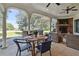 Covered outdoor patio with fireplace, summer kitchen, dining, and lounging area at 160 Isleworth Way, Fayetteville, GA 30215