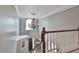 Staircase featuring a decorative chandelier and wood railing at 160 Isleworth Way, Fayetteville, GA 30215