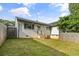 Fenced backyard with grassy lawn and access to the back of the home at 2677 Tilson Rd, Decatur, GA 30032