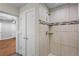 Modern tiled shower with decorative accents and bathroom with hardwood floors at 2677 Tilson Rd, Decatur, GA 30032