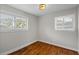 Bright bedroom with hardwood floors, two windows, and natural light at 2677 Tilson Rd, Decatur, GA 30032