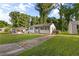 Charming white brick home with long driveway and grassy front yard with mature trees at 2677 Tilson Rd, Decatur, GA 30032