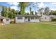 Charming one-story home with white painted brick, wood shutters, and a spacious front lawn at 2677 Tilson Rd, Decatur, GA 30032
