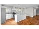 Spacious kitchen with stainless steel appliances, granite countertops, herringbone backsplash, white island and hardwood floors at 2677 Tilson Rd, Decatur, GA 30032