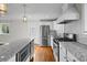 Modern kitchen with granite countertops, stainless steel appliances, white cabinets, stylish tile backsplash, and hardwood floors at 2677 Tilson Rd, Decatur, GA 30032