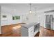 Bright, updated kitchen with granite island, stainless appliances, recessed lighting, hardwood floors and access to backyard at 2677 Tilson Rd, Decatur, GA 30032