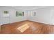 Sunlit living room featuring hardwood floors, white walls, and view of backyard at 2677 Tilson Rd, Decatur, GA 30032