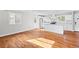 Open layout showcases a modern kitchen and living area with hardwood flooring and natural light at 2677 Tilson Rd, Decatur, GA 30032