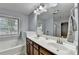 Bathroom with double sinks, a large mirror, and a separate glass-enclosed shower and tub at 3351 Vintage Se Cir, Smyrna, GA 30080