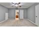 Bedroom featuring gray walls, carpet, ceiling fan, and access to the bathroom at 3351 Vintage Se Cir, Smyrna, GA 30080
