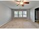 Bedroom featuring a ceiling fan and three windows, providing ample natural light at 3351 Vintage Se Cir, Smyrna, GA 30080