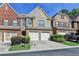 Charming townhome with brick facade, two-car garage, and well-maintained landscaping at 3351 Vintage Se Cir, Smyrna, GA 30080