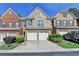 Charming townhome with brick facade, two-car garage, and well-maintained landscaping at 3351 Vintage Se Cir, Smyrna, GA 30080