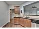 Charming kitchen featuring wood cabinets, stainless dishwasher, and views into the living space at 3351 Vintage Se Cir, Smyrna, GA 30080