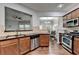 Open kitchen view with stainless appliances, breakfast bar, and hardwood flooring at 3351 Vintage Se Cir, Smyrna, GA 30080