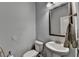 Cozy powder room with pedestal sink, decorative mirror, and neutral color scheme at 3351 Vintage Se Cir, Smyrna, GA 30080
