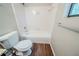 Clean bathroom featuring a white toilet, shower and tub combination, and wood-look flooring at 1934 Patton Pl, Lithonia, GA 30058