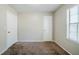 Bedroom featuring a neutral-toned carpet, white walls, window with blinds, and two closets at 1934 Patton Pl, Lithonia, GA 30058