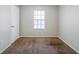 Neutral bedroom with carpet floor, window with blinds, and white door at 1934 Patton Pl, Lithonia, GA 30058