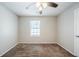 A bright bedroom features neutral colored walls, carpet flooring, and a ceiling fan at 1934 Patton Pl, Lithonia, GA 30058