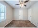 Bright bedroom featuring neutral walls, carpet flooring, ceiling fan, and two closets at 1934 Patton Pl, Lithonia, GA 30058