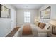 Stylishly staged bedroom with neutral decor, offering a serene and inviting space with ample natural light at 1934 Patton Pl, Lithonia, GA 30058