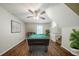 The bonus room is complete with a pool table, staircase, and ceiling fan, great for entertaining and relaxing at 1934 Patton Pl, Lithonia, GA 30058