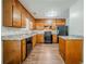 Well-lit kitchen with wood cabinets, sleek countertops, and modern black appliances at 1934 Patton Pl, Lithonia, GA 30058