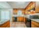 Bright kitchen featuring abundant counter space, wooden cabinetry, and stainless appliances at 1934 Patton Pl, Lithonia, GA 30058