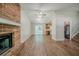 Open-concept living room with brick fireplace, durable floors, and access to the kitchen at 1934 Patton Pl, Lithonia, GA 30058