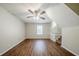 Bright open floor plan featuring laminate flooring, staircase, and ceiling fan at 1934 Patton Pl, Lithonia, GA 30058
