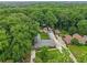 Areal view showing the property nestled among trees with its residence, guest house, and carport at 2624 Lake Erin Drive Dr, Tucker, GA 30084
