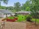 Beautiful backyard with red raised garden beds, gravel area, and exterior views of all structures at 2624 Lake Erin Drive Dr, Tucker, GA 30084