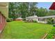 Expansive backyard with a lush lawn, guest house, and carport, perfect for outdoor activities at 2624 Lake Erin Drive Dr, Tucker, GA 30084