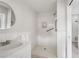 All-white bathroom features a sink, mirror, and walk-in shower at 2624 Lake Erin Drive Dr, Tucker, GA 30084