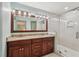Well-lit bathroom featuring double sinks, granite countertops, and a glass-enclosed shower at 2624 Lake Erin Drive Dr, Tucker, GA 30084