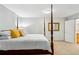 Spacious bedroom featuring a four-poster bed, soft carpet, and a serene, light-filled ambiance at 2624 Lake Erin Drive Dr, Tucker, GA 30084