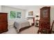 Cozy bedroom featuring large window, bed, carpet, and antique furniture, creating a restful retreat at 2624 Lake Erin Drive Dr, Tucker, GA 30084