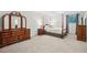 Bedroom with a 4-poster bed and a dark wood dresser with mirror at 2624 Lake Erin Drive Dr, Tucker, GA 30084