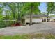 Exterior view of the building with covered parking, surrounded by trees at 2624 Lake Erin Drive Dr, Tucker, GA 30084
