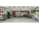 Spacious three-car garage interior features storage shelves, lighting, and an overhead door at 2624 Lake Erin Drive Dr, Tucker, GA 30084