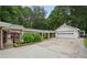Detached three-car garage with breezeway connects to the main house, offering parking and storage at 2624 Lake Erin Drive Dr, Tucker, GA 30084