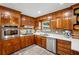Well-maintained kitchen featuring wood cabinets, stainless steel appliances, and tile backsplash at 2624 Lake Erin Drive Dr, Tucker, GA 30084